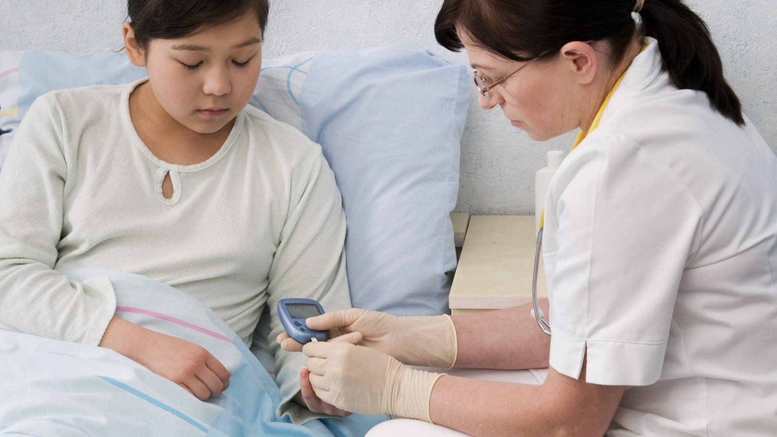 diabetic child gets blood sugar tested