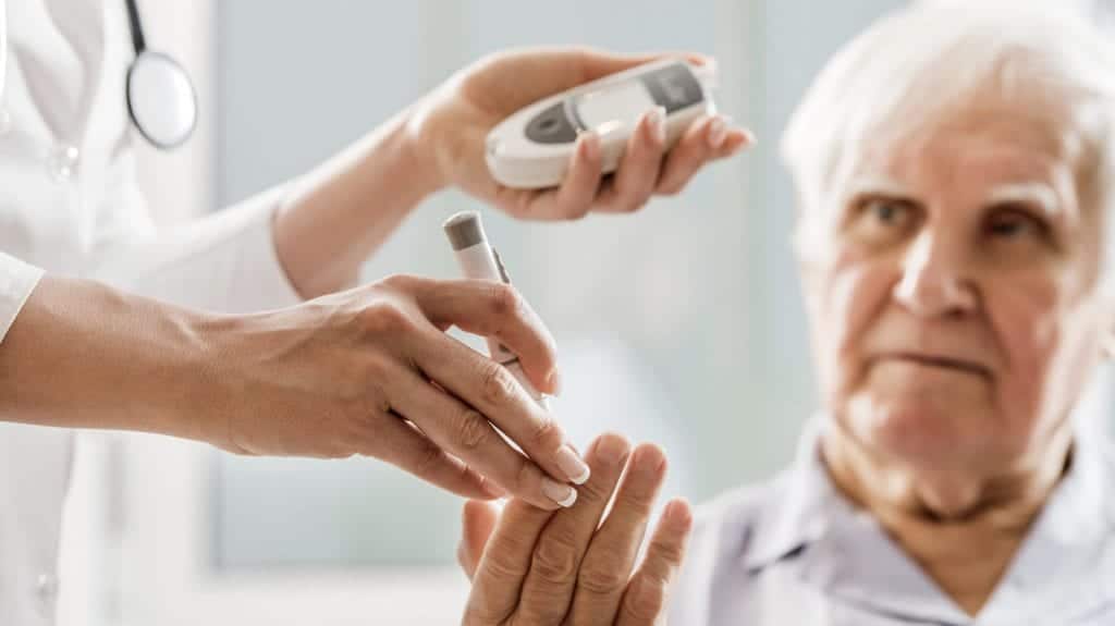 Elderly Man Having Blood Sugar Tested Stock Photo