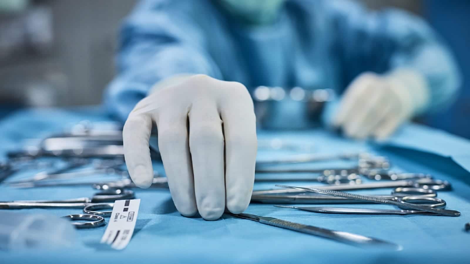Surgeon Reaching For Medical Tools Stock Photo