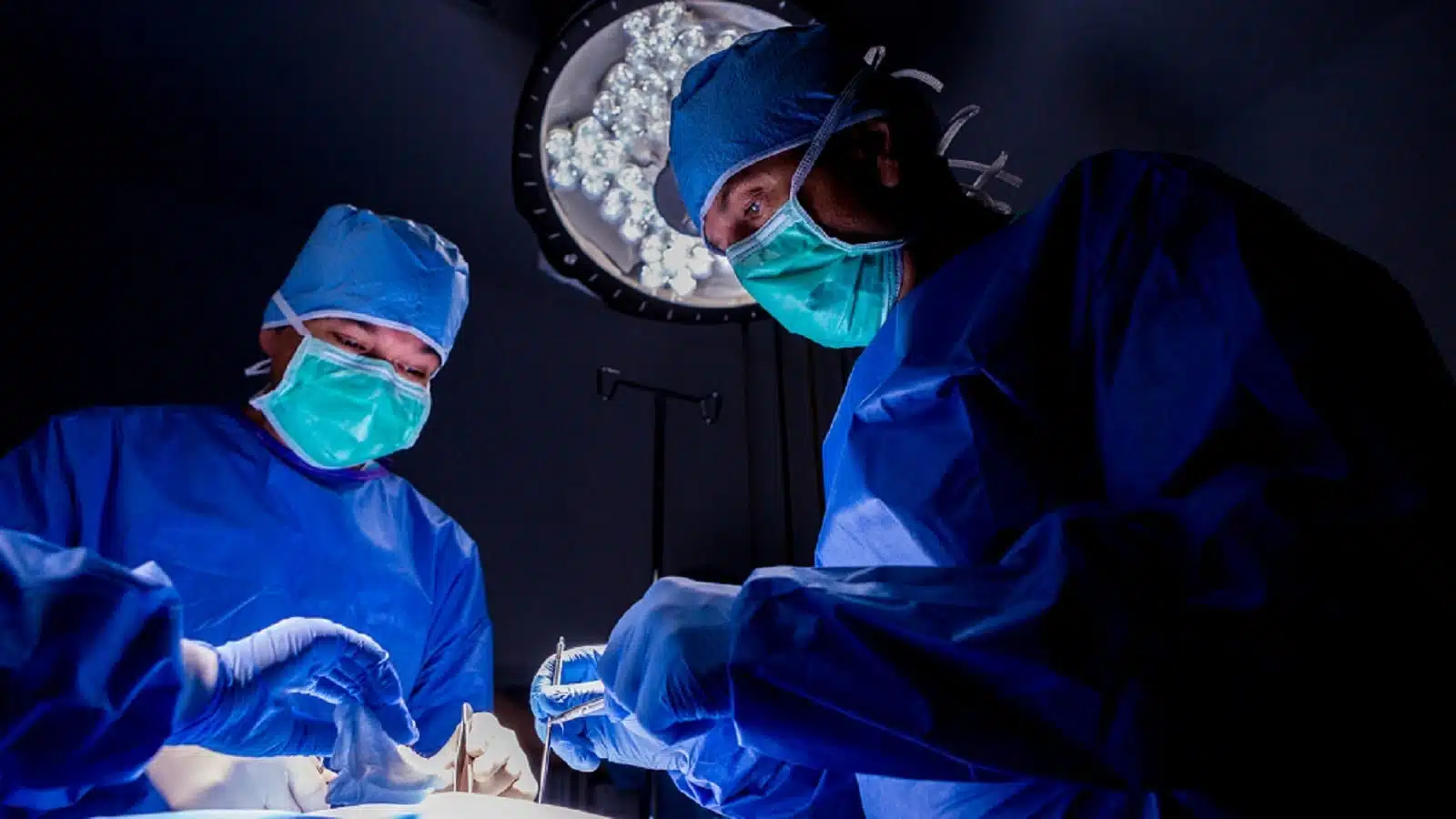 Surgeons Performing Surgery In The Operating Room