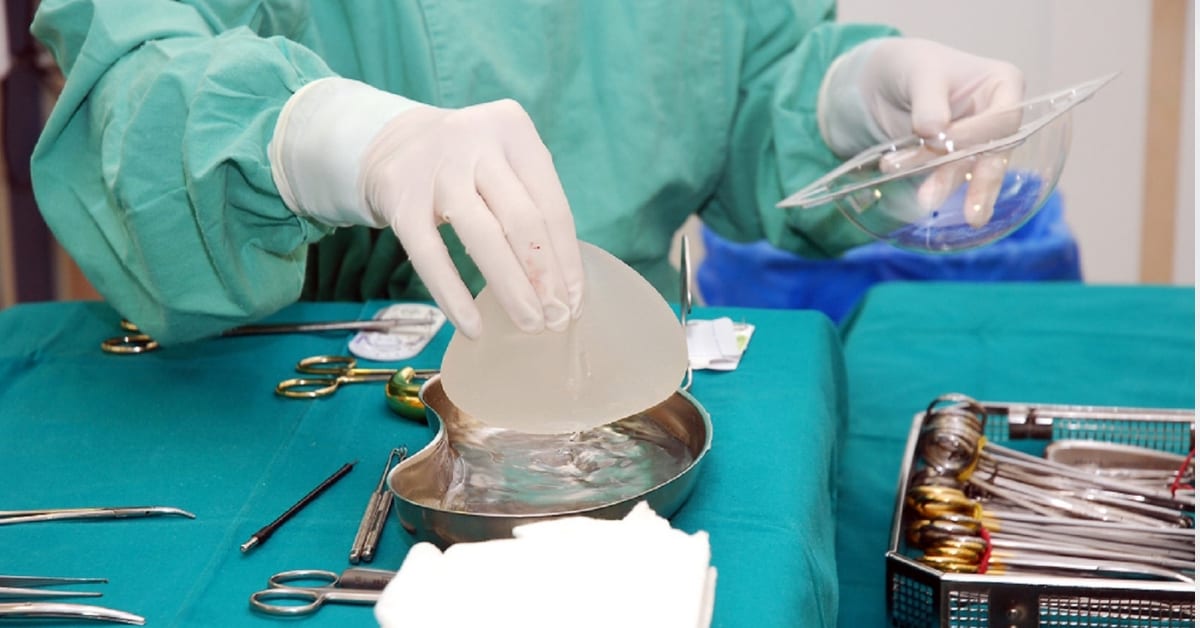 Surgeon Working At Surgery Table With Breast Implants