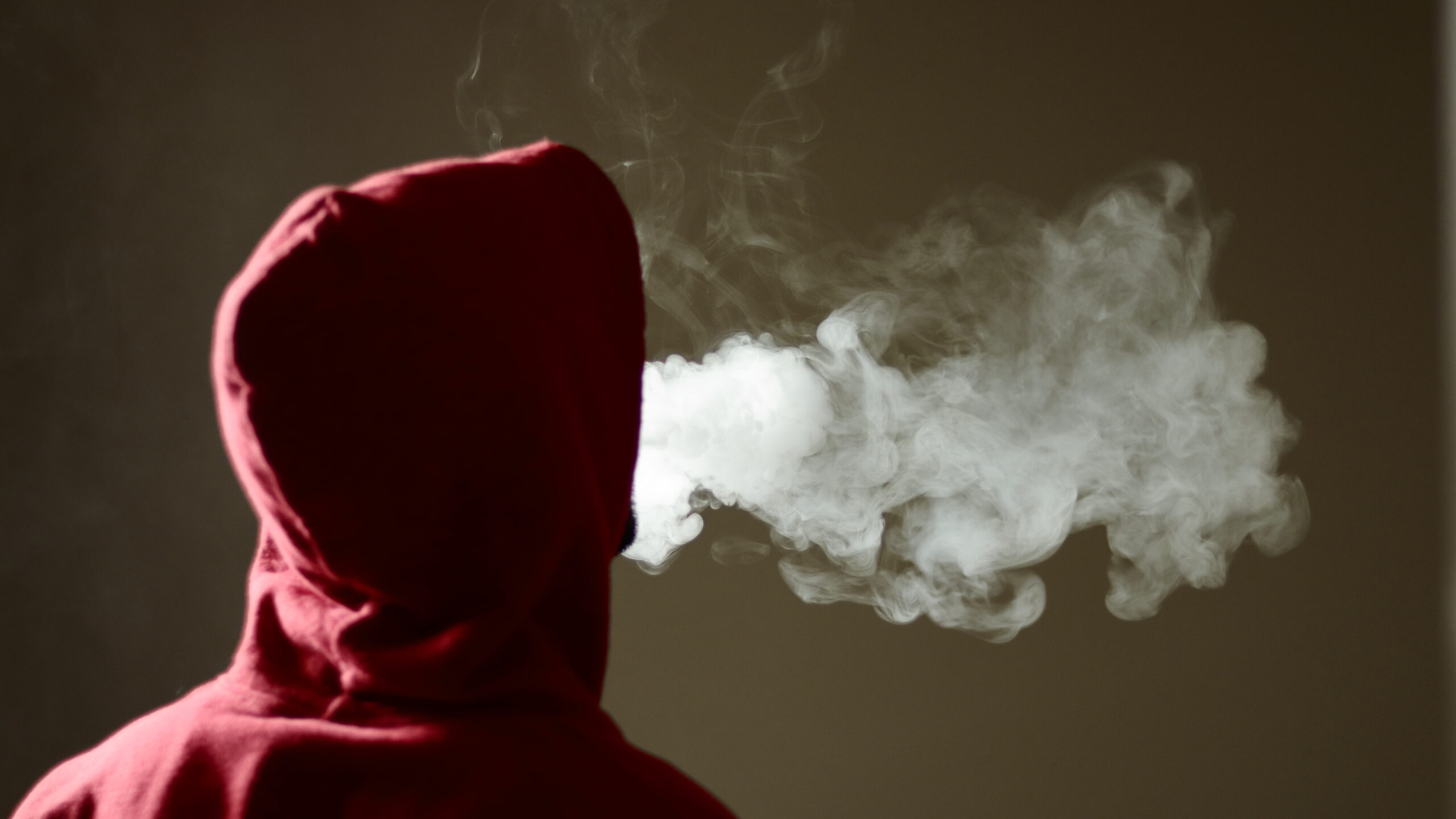 young-man-in-hoodie-vaping