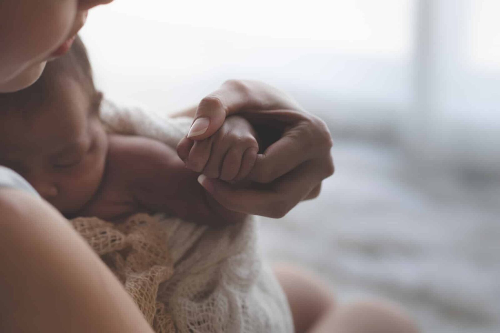 woman holding her child after experiencing a birth injury