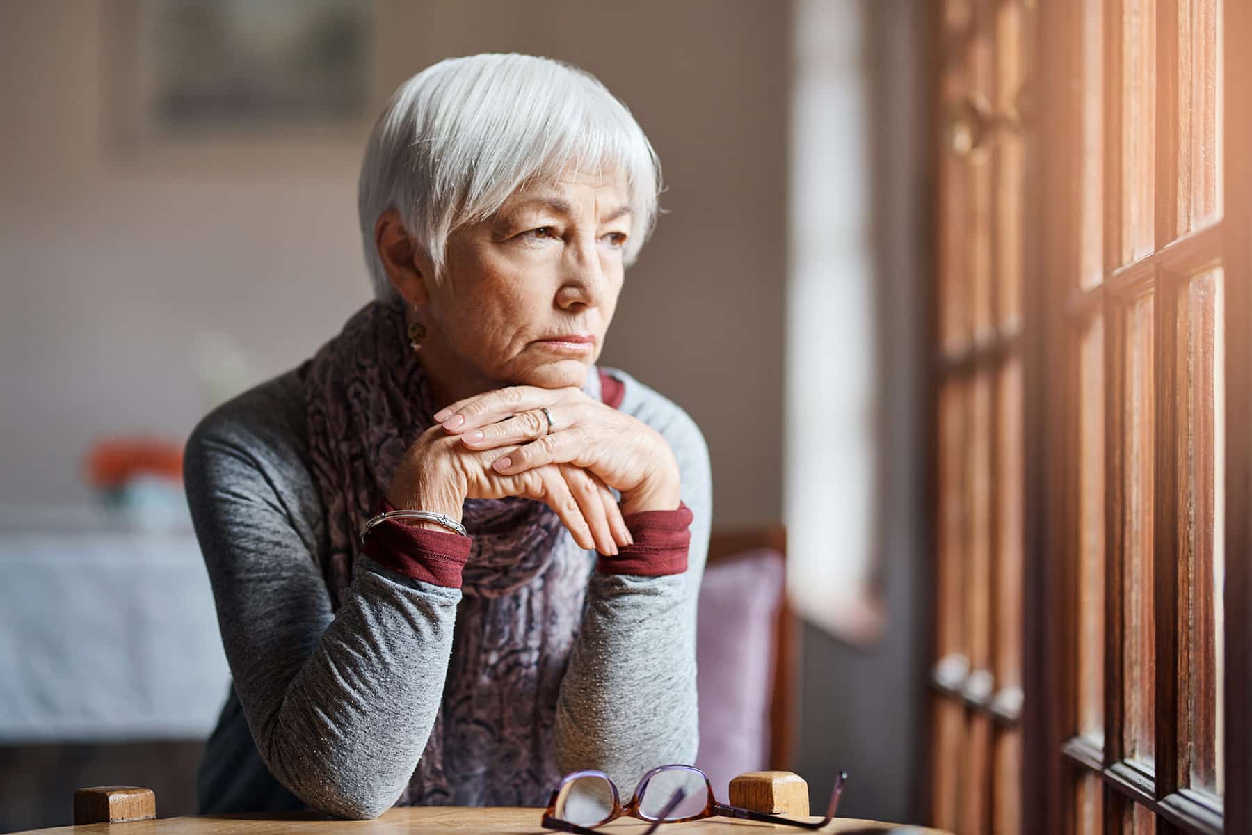 elder woman feeling sad after experiencing nursing home abuse