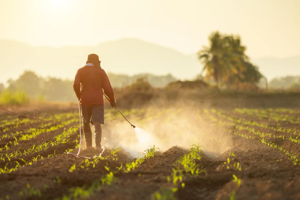 farmer spraying Roundup® weed killer on his crops